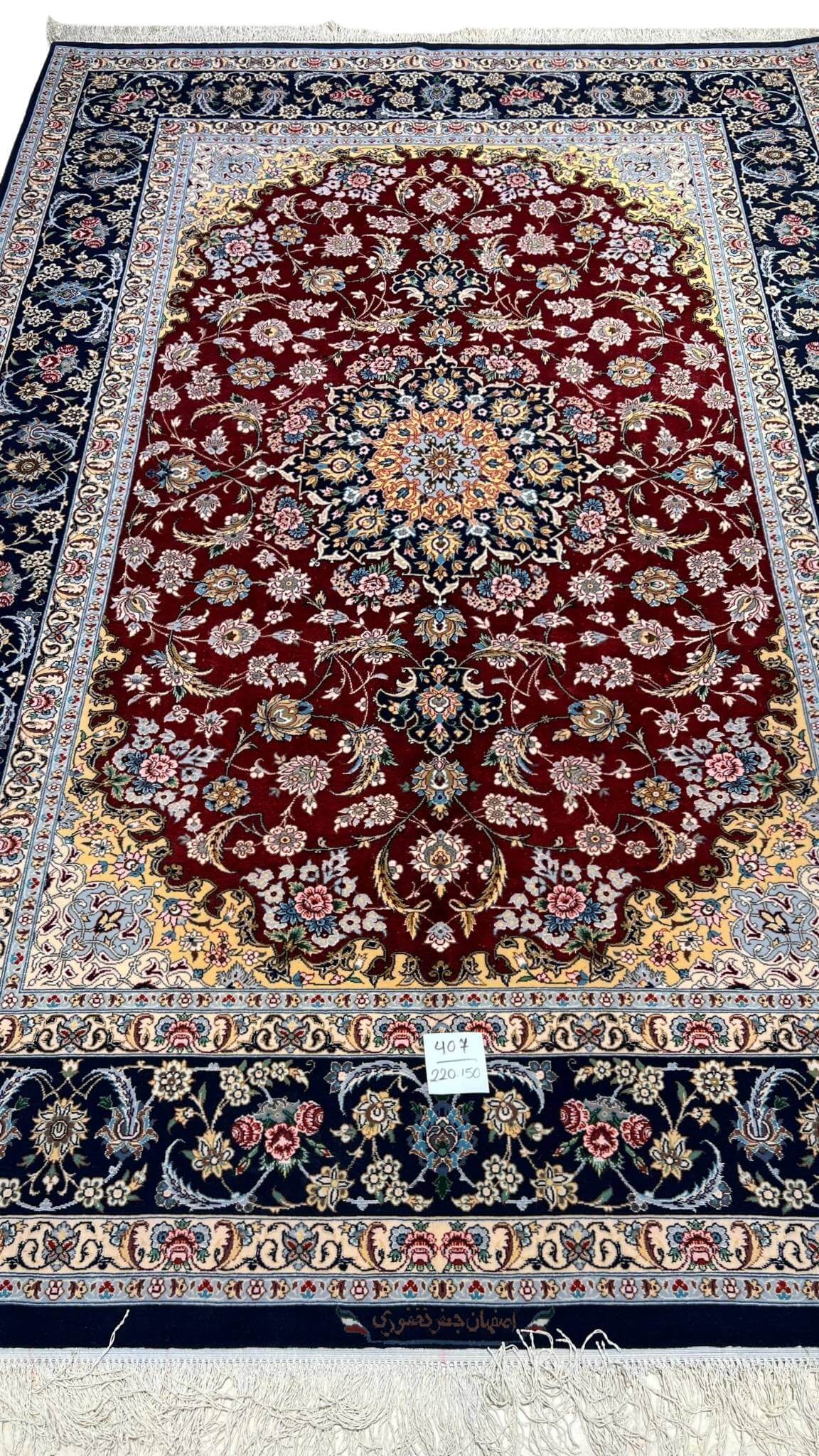 Hand-knotted red and black Persian rug with floral design by Jafar Fakhforie